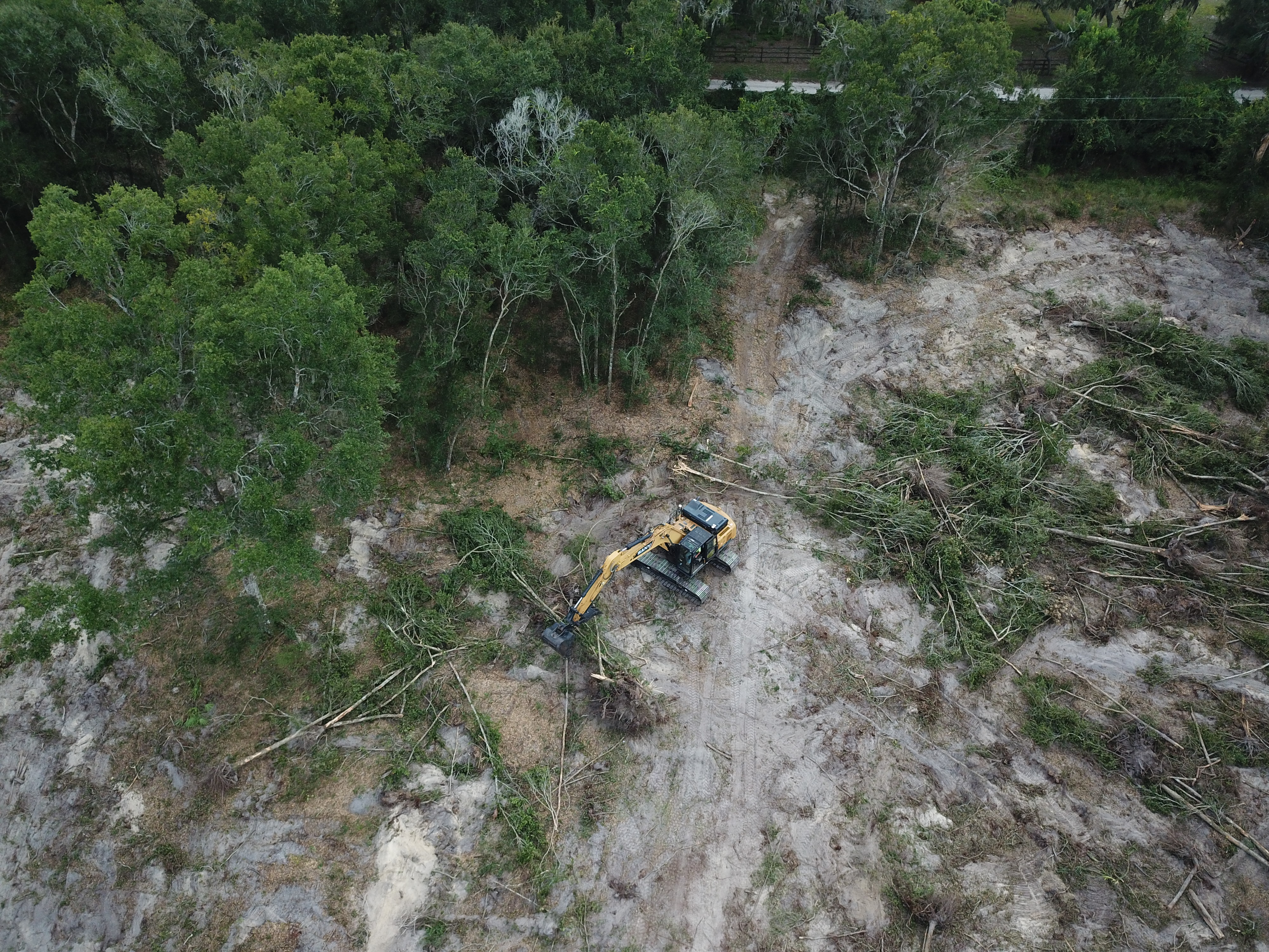 Excavator grading a residential lot.